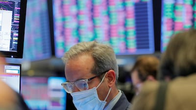 A trader wearing a mask on the floor of the New York Stock Exchange last week before it temporarily closed in a bid to stop the spread of coronavirus. Some US states have already issued shutdown orders to prevent the spread of the virus. Reuters.