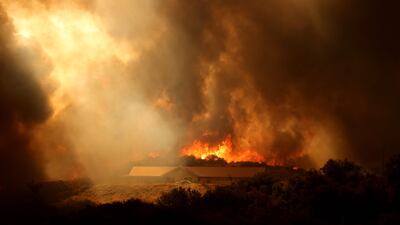 A mountainside is engulfed in flames as the Airport Fire gains ground near Lake Elsinore, California. AFP