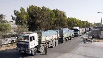 A Palestinian worker checks a truck carrying supplies after it arrived in Rafah town through the Kerem Shalom crossing between Israel and the southern Gaza Strip on Wednesday, June 16, 2010.