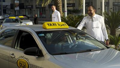 Taxi drivers receive iftar gift packs filled with biryani, dates, juice, water and fruit from the Starwood Group. Christopher Pike / The National