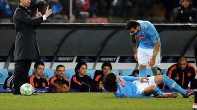 Andre Villas-Boas gestures as Napoli's Ezequiel Lavezzi, right, and Edinson Cavani, bottom, celebrate in Naples.