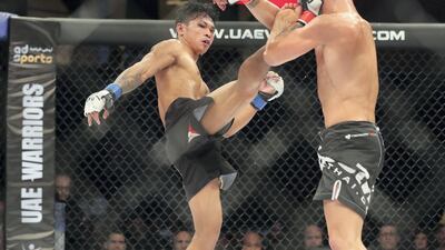 Trent Girdham (black gloves) takes on Jayson Margallo in the bantamweight division. Chris Whiteoak / The National