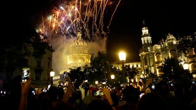 People take pictures of the fireworks at the Capitol during a gala as part of the celebration of the 500 years of the city in Havana, Cuba. AP