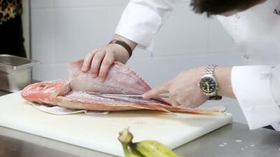 Phillip Harbin, chef de cuisine prepares snapper for a Ceviche Masterclass. Christopher Pike / The National