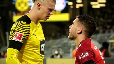 Dortmund's Erling Haaland, left, goes head to head with Bayern's Lucas Hernandez after a challenge. AP Photo