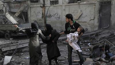 Syrians run for cover following Syrian government air strikes on the Eastern Ghouta rebel-held enclave of Douma, on the outskirts of the capital Damascus on March 20, 2018. (AFP)