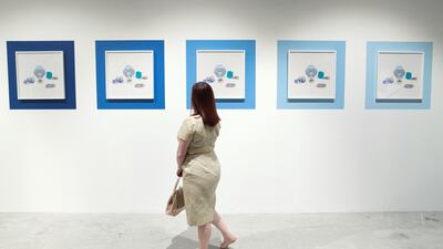 A spectator at the Gateway: Fragments, Yesterday and Today exhibition during the 11th edition of Abu Dhabi Art. Reem Mohammed / The National
