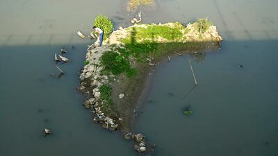 A man fishes along Jhelum river in Srinagar, Kashmir, which is battling a dry spell. AFP