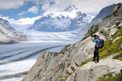 Photographer David Carlier photographs the Swiss Aletsch glacier, the longest glacier in Europe, in Switzerland on July 21. AP