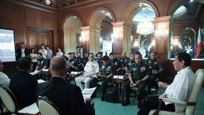 Philippine President Rodrigo Duterte, right, meets security officials at the Malacanang presidential palace in Manila on January 5, 2020. Malacanang Presidential Photographers Division via AP
