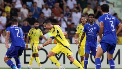 Al Nassr's Cristiano Ronaldo takes on the Esteghlal defence.