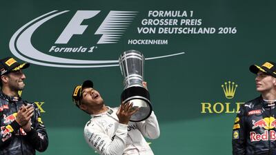 Red Bull’s Daniel Ricciardo applauds as an elated Lewis Hamilton lifts his trophy after winning the German Grand Prix in Hockenheim. Ricciardo was second. Jens Meyer / AP Photo