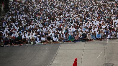 A Muslim girl walks as she attends Eid Al Adha prayers on a street in Jakarta, Indonesia. Reuters