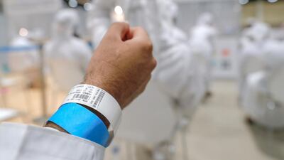 Volunteers wait their turn to be inoculated with the first of two Covid-19 vaccines. Victor Besa / The National