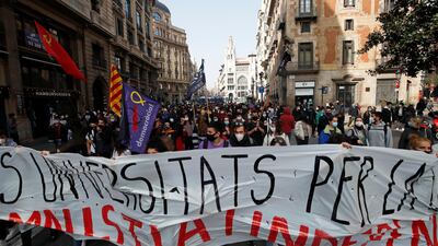 Demonstrators in Barcelona hold a banner during a protest in support of Catalan rapper Pablo Hasel, after he was given a jail sentence on charges of glorifying terrorism and insulting royalty in his songs,. Reuters