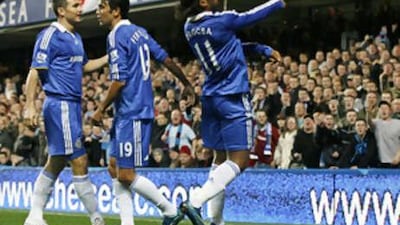 Didier Drogba, right, throws a coin back into the crowd during Chelsea's League Cup game against Burnley.