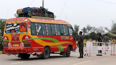 A Pakistani security official checks a bus carrying passengers to India, as Pakistan is set to free Indian fighter pilot Abhinandan Varthaman, at Pakistan-India joint border Wagah, near Lahore, Pakistan, 01 March 2019. According to media reports, Pakistan is set to hand over IAF Wing Commander Abhinandan as a 'peace gesture' to India after he was taken into custody by the Pakistan forces after his jet was downed in Pakistan territory. EPA