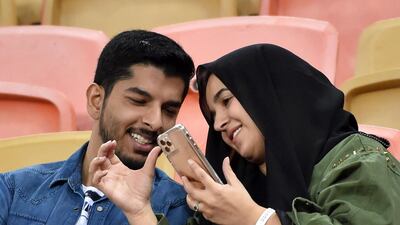 A Saudi couple attends a football match in Jeddah. Women have recently been allowed to attend sporting events. AFP