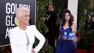 Jamie Lee Curtis with the 'Fiji Water Girl' at the 76th annual Golden Globe Awards, in an image distributed for Fiji Water. Getty Images