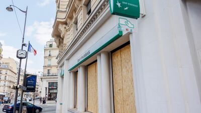 Branch of BNP Paribas bank on Rue La Boetie in Paris with windows boarded up amid nationwide rioting. EPA