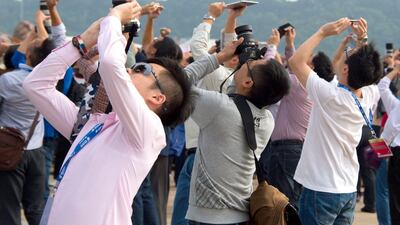 Spectators watch the Airshow China 2014 in Zhuhai. Johannes Eisele / AFP