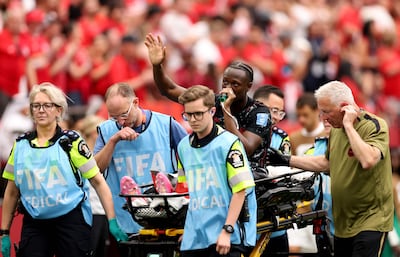 Ismael Kone of Canada waves to the crowd as he is stretched off. AFP
