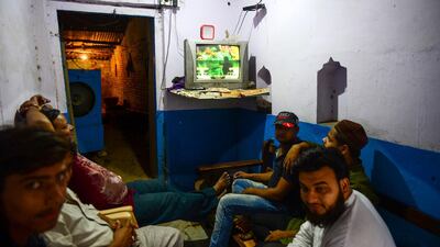 Indian people watch a live broadcast of the match on a television at a tea shop in Allahabad. AFP