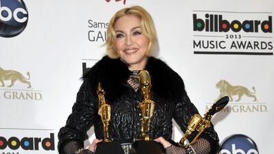 Madonna poses backstage with her awards for top touring artist, dance album and dance artist. John Shearer / Invision / AP