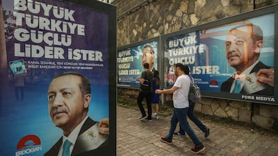 In this photo taken on Saturday, June 9, 2018, people walk past election posters of Turkey's President Recep Tayyip Erdogan and his ruling Justice and Development (AKP) Party in Istanbul. The most powerful and polarising leader in Turkish history is standing for re-election in a presidential vote on Sunday that could cement Turkey's switch from a parliamentary to a presidential system, which was narrowly approved in a referendum last year. Emrah Gurel / AP