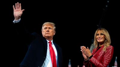 US President Donald Trump waves as he leaves the stage with First Lady Melania Trump at the end of a rally to support Republican Senate candidates at Valdosta Regional Airport in Valdosta, Georgia. AFP