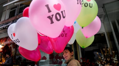 An Afghan boy sells Valentine's Day balloons on a street in Kabul. AP