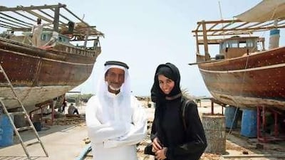 Juma al Qubaisi stands next to his fishing boats with his daughter, Ayesha. Mr al Qubaisi hopes that tourism projects will provide more jobs for the young residents of Dalma.