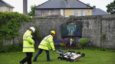 Engineers use ground-penetrating radar at the site of a mass grave of up to nearly 800 children at the former Bon Secours Mother and Baby Home in Tuam, western Ireland, on June 6, 2014. Aidan Crawley / EPA