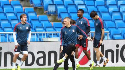 Bastian Schweinsteiger, centre, stretches during their Bayern Munich training at the Santiago Bernabeu Stadium ahead of the Uefa Champions League semi-final first leg match against Real Madridon April 22, 2014 in Madrid, Spain. Martin Rose/Getty Images