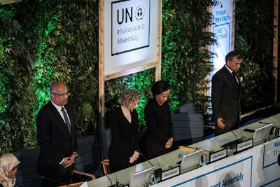 People hold a moment of silence for the victims, including 19 UN workers, of the Ethiopia Airlines crash before the UN Environment Assembly in Nairobi. AFP