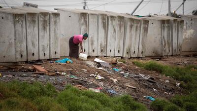 This photo shows a woman throwing out waste water next to a line of toilets in an informal settlement in Langa, a mostly impoverished township, about 10km from the centre of Cape Town. The Sustainable Development Goals include a target to ensure everyone has access to a safely-managed household toilet by 2030. AFP