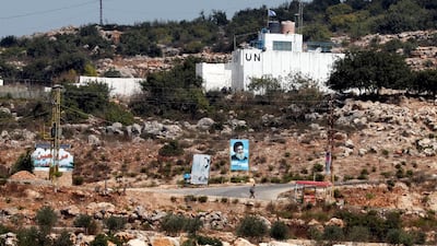 A banner depicting Hezbollah leader Hassan Nasrallah and an United Nation's post are seen in Lebanon from the Israeli side of the border, near Zar'it in northern Israel August 28, 2019. Reuters