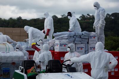 Airport staff and Royal Australian Air Force personnel transfer boxes of humanitarian aid transported by a Royal Australian Air Force C-17A Globemaster III to Port Vila airport, following Cyclone Harold. Reuters