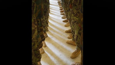 Afghanistan National Army (ANA) soldiers are briefed at Forward Operating Base Delhi, where US Marines from Kilo Company 3rd Battalion 8th Marines Regiment are posted in Garmser, Helmand Province on June 29, 2012. Some 130,000 NATO troops are due to leave Afghanistan by the end of 2014 and there are fears that their exit will lead to a reduction in rights and freedoms in the war-torn country. AFP PHOTO / ADEK BERRY