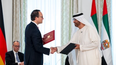 Dr Sultan Al Jaber, UAE Minister of Industry and Advanced Technology and managing director and group chief executive of Adnoc and chairman of Masdar, and RWE chief executive Markus Krebber exchange a Memorandum of Understanding, at Al Shati Palace. UAE Presidential Court