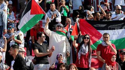 Palestine supporters cheer ahead of match. AFP