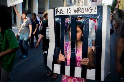 Fiona Pompilio, 10, of Philadelphia marches by Rittenhouse Square as protestors gather near a hotel hosting a GOP fundraiser with Vice President Mike Pence Tuesday, June 19, 2018 in Philadelphia, Pa. The demonstration is a reaction to children being separated from their families by immigration officials. (Joe Lamberti/Camden Courier-Post via AP)