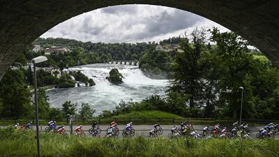 Riders pass the Rhine Falls during the second stage of the 84th Tour de Suisse cycling race from Neuhausen am Rheinfall to Lachen, Switzerland. EPA