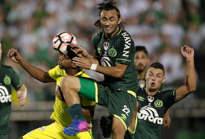 In this file photo from April 4, 2017 photo, Luis Carlos Ruiz of Colombia's Atletico Nacional, left, fights for the ball with Apodi of Brazil's Chapecoense at a Recopa Sudamericana first-leg final match in Chapeco, Brazil. Andre Penner / AP Photo
