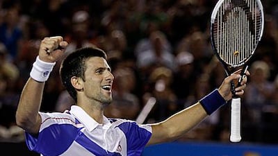 Serbia's Novak Djokovic raises his arms in celebration after clinching his second grand slam title.