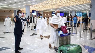 Mask-clad Pakistani travellers arriving in Saudi Arabia. AFP