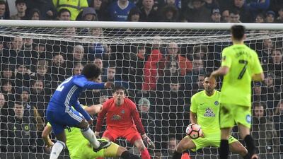 Chelsea midfielder Willian shoots to score his side’s third goal. Glyn Kirk / AFP