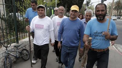 The head of Israel's Arab parliamentary bloc Ayman Odeh, left, walks alongside supporters as they arrive in Jerusalem on March 29, 2015, after a four-days march from the Bedouin village of Wadi Al Naam, near the city of Beersheba, to support Bedouin Arabs. Ahmad Gharabli/AFP Photo