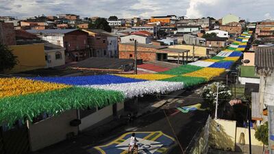 A boy rides his bicycle along Third Street of the Alvorada neighbourhood which is decorated for the 2014 World Cup in Manaus, one of the tournament’s host cities. Bruno Kelly/ Reuters