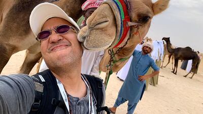 The National's Victor Besa gets a wet kiss on the face from a beauty contestant at Al Dhafra festival. Victor Besa / The National
